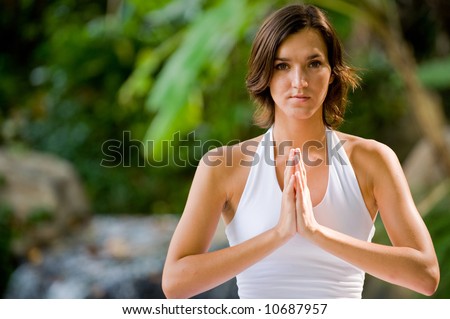 A young woman practising yoga outside