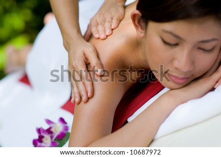 A young woman enjoying a massage outside