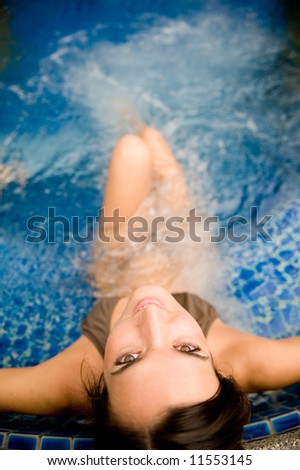 A young attractive woman in a spa pool