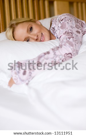 A young woman in pyjamas in bed
