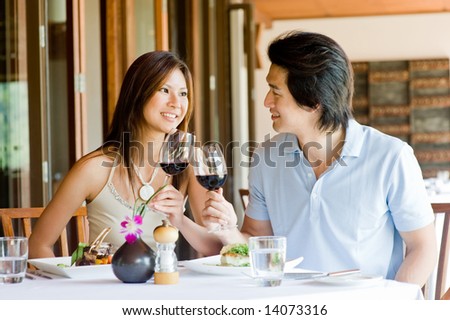 A young Asian couple having dinner at a restaurant