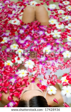 A woman in bath of flowers