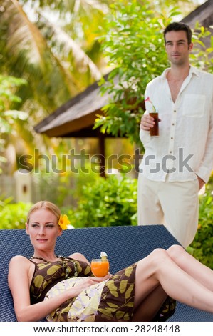 An attractive couple having drinks on vacation