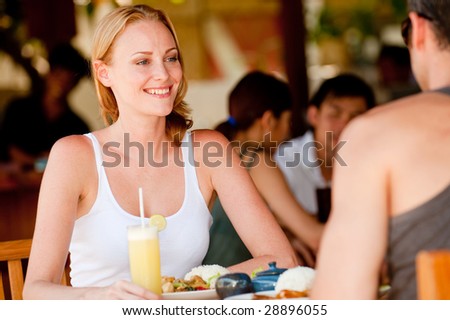 A young couple on vacation enjoying lunch at a restaurant