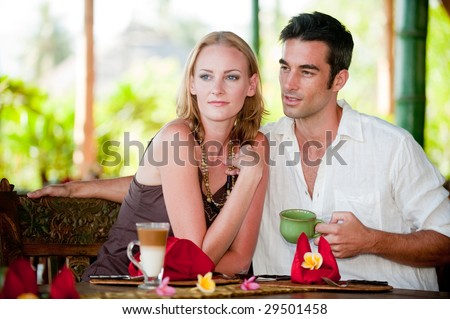 A young couple enjoying breakfast whilst on vacation