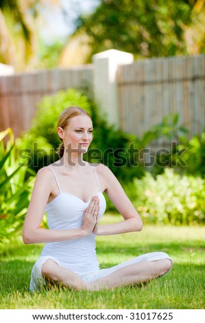 A young attractive woman sitting outside looking calm and relaxed