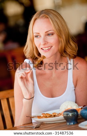 A young woman on vacation enjoying lunch at a restaurant
