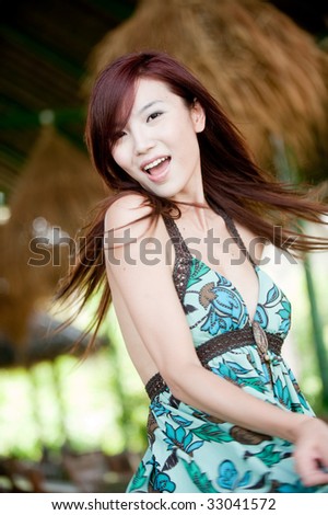 An attractive Chinese woman in a summer dress