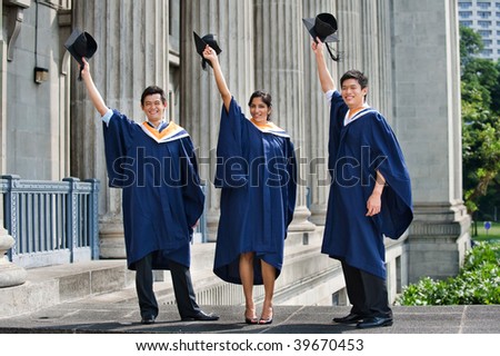 A group of graduates toss their mortar boards into the air