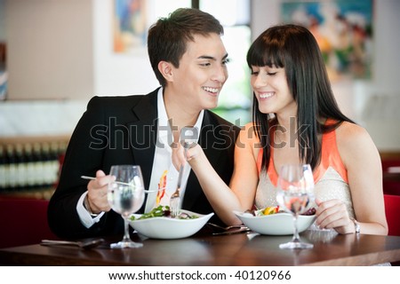 A young and attractive couple dining in a restaurant