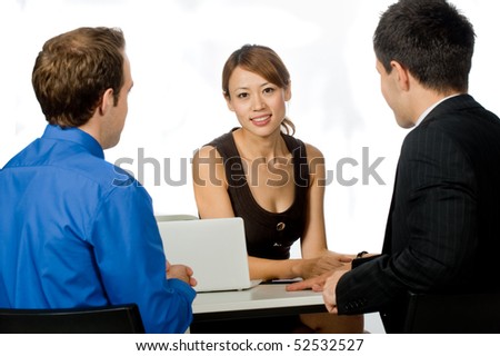 A young and professional businesswoman having a discussion with two of her colleagues on white background