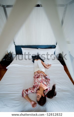An attractive caucasian woman sleeping peacefully on her bed