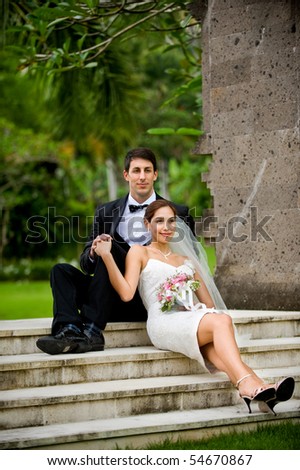 Attractive caucasian newly weds getting married outdoors in a garden