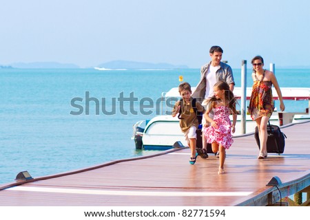 A family of 4 arriving at the resort with their luggage.