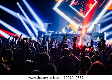 Dj party at nightclub. Crowd rave at the stage background. Stranger Dj\'s