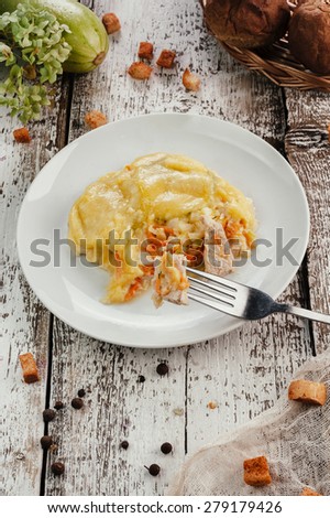 Traditional casserole with meet and vegetable in white plate