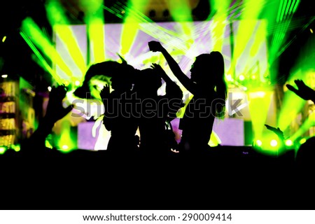 night club party festival crowd hands up dance  with girls silhouettes. green light