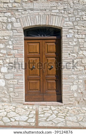 Wooden door with a stone door frame - Tuscany - Italy