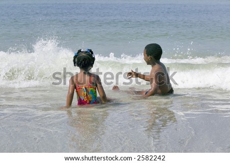 Young african american brother and sister enjoy a day playing at the beach