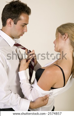 Male and female business coworker making out against a white background