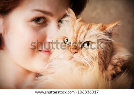 Young woman with Persian cat smiling portrait