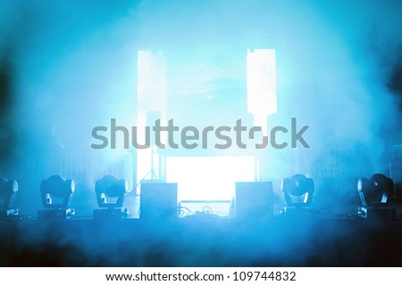 Empty concert stage in disco lights and smoke