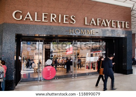 PARIS - OCT 2: Shoppers walk past the entrance to Lafayette shopping center on October 2, 2012 in Paris. The Galeries Lafayette has been selling luxury goods since 1895.