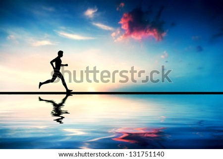 Silhouette Of Man Running At Sunset. Water Reflection