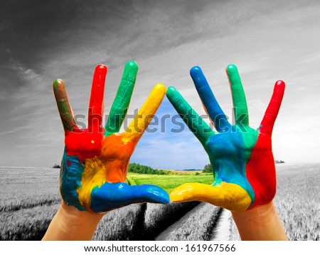 Painted colorful hands showing way to colorful happy life, conceptual.