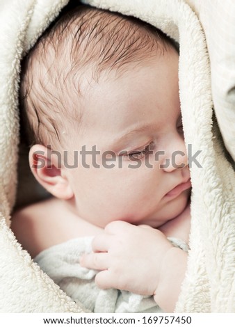 Lovely 3 months baby sleeping in soft blanket, close up face portrait