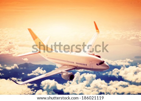Airplane in flight. A big passenger or cargo aircraft, airline above clouds. Travel, transportation, transport, business in motion.