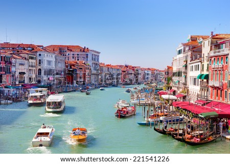 ITALY, VENICE - AUGUST 25 -  Gondolas and tourist boats traffic on the Grand Canal on August 25, 2014 in Venice, Italy. The entire city with its lagoon is listed on the World Heritage Site