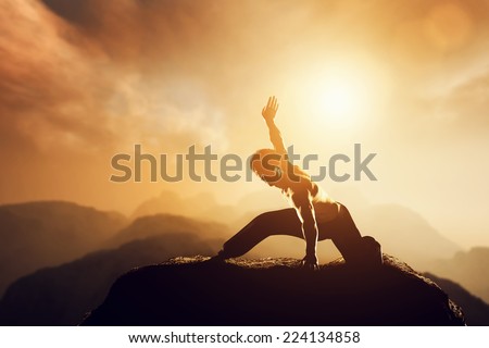 Asian man, fighter practices martial arts in high mountains at sunset. Kung fu and karate pose. Also concepts of discipline, concentration, meditaion etc. Unique