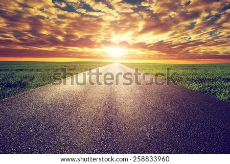 Long straight road, way towards sun. Sunset sky, travel, transport, destination concepts.