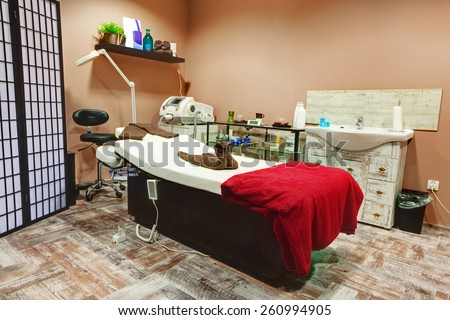 Beauty salon interior. Relaxing, zen design with table for treatment and massage