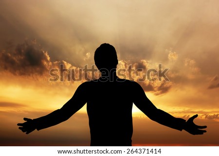 Man praying, meditating in harmony and peace at sunset. Religion, spirituality, prayer, peace.