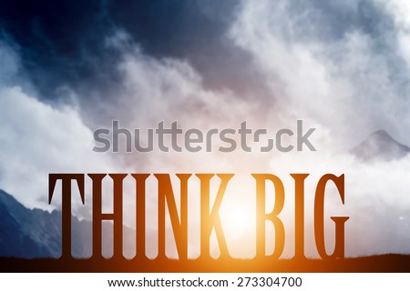 THINK BIG text on mountains landscape at sunset dramatic sky. Motivational, inspirational