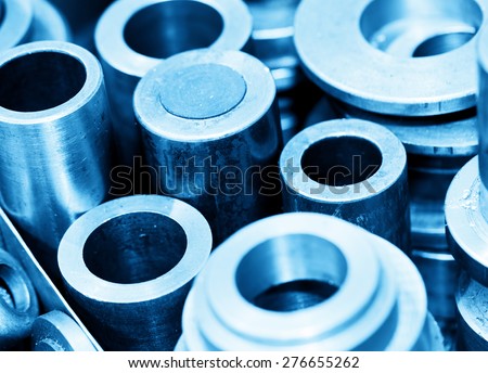 Industrial steel cylinders, pistons and tools in workshop. Industry theme.