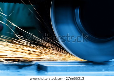 Sparks from grinding machine in workshop. Industrial background, industry.