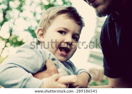 Son with father, happy moments together. Happy childhood. Vintage