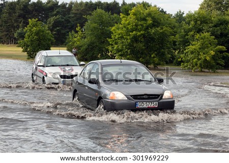 GDANSK, POLAND - July 28: Cars trying to drive against flood on the street on July 28, 2015 in Gdansk, Poland. Storms and heavy rains hit many parts of Poland and Europe