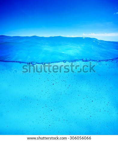 Underwater background ready for design. Clean and clear pure waterline with small water drops flowing.