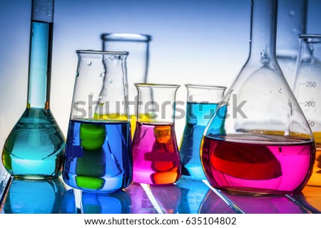Laboratory glass filled with colorful substances. Chemical liquids analysis and testing.