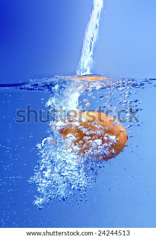 Orange splashing into water background