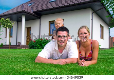 Happy family in front of their house