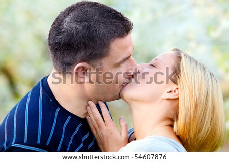 Love kissing. Happy couple kissing in romantic scenery