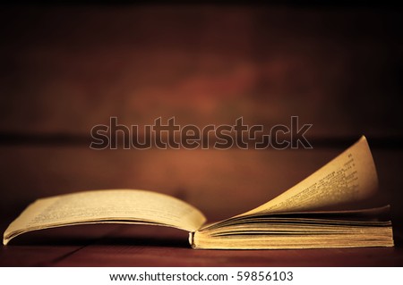 Open book in retro style on wooden background. Education concepts
