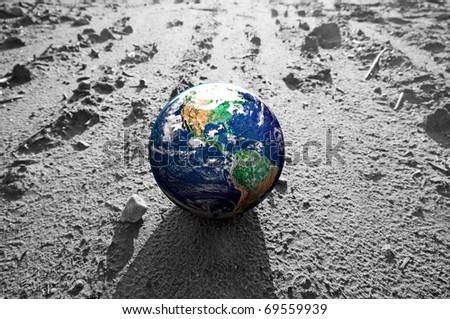 The Earth globe on rocky Mars like surface. Concepts of Earth protection, environment, global warming, disasters etc.