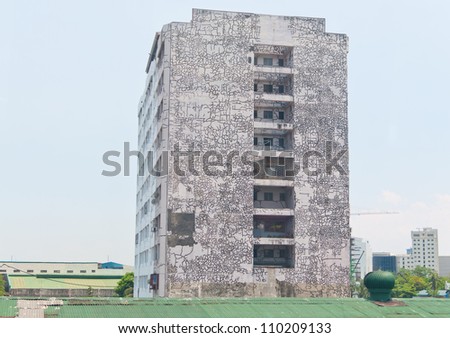 a leaning old building with cracking paint