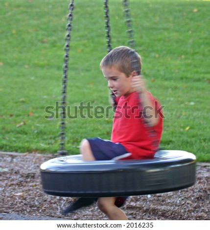 Boy on Tire Swing Dizzy with motion blur